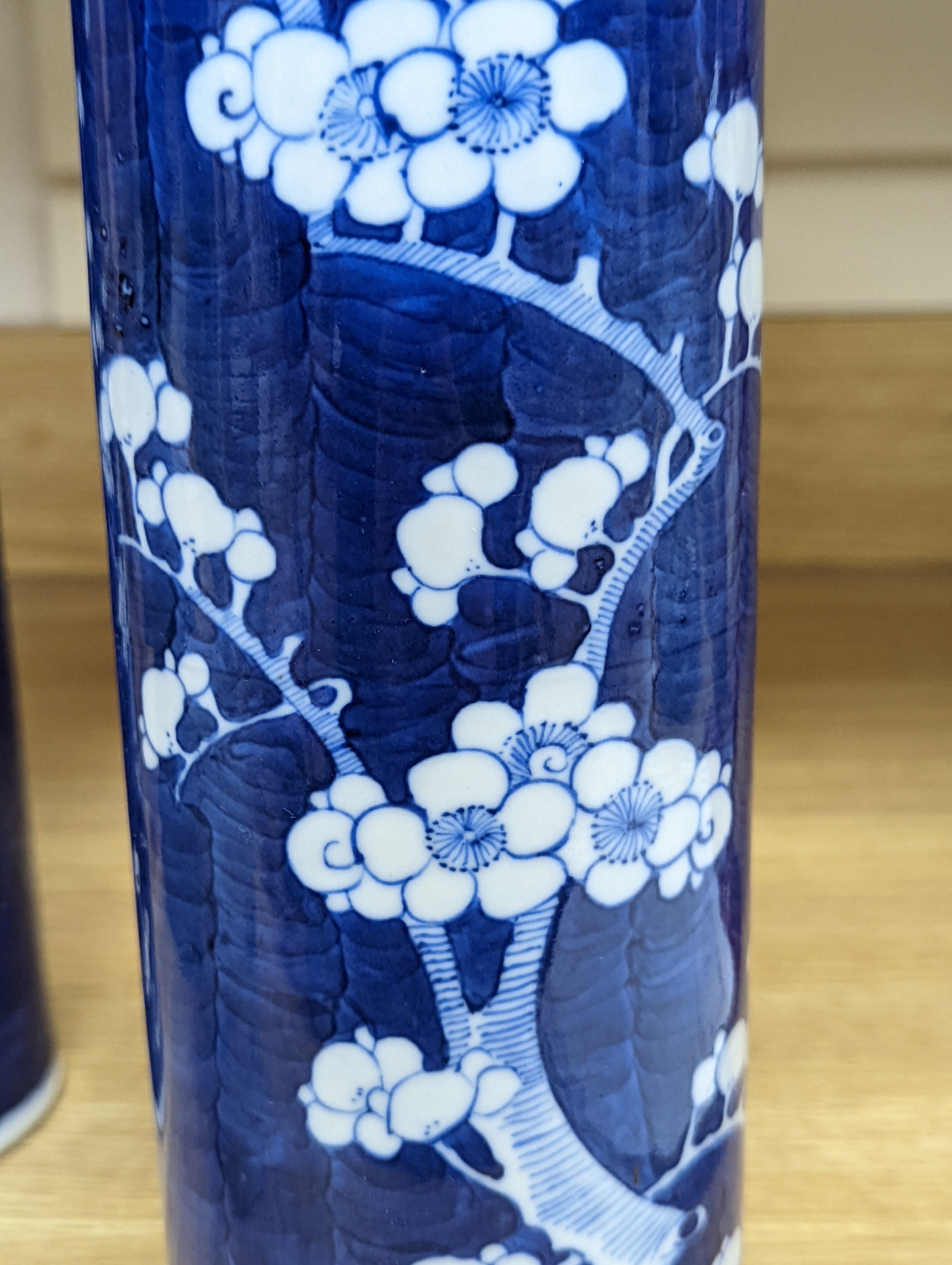 An 18th century Chinese famille rose mug, a Chinese Imari tea caddy and two Chinese blue and white sleeve vases 30cm (4)